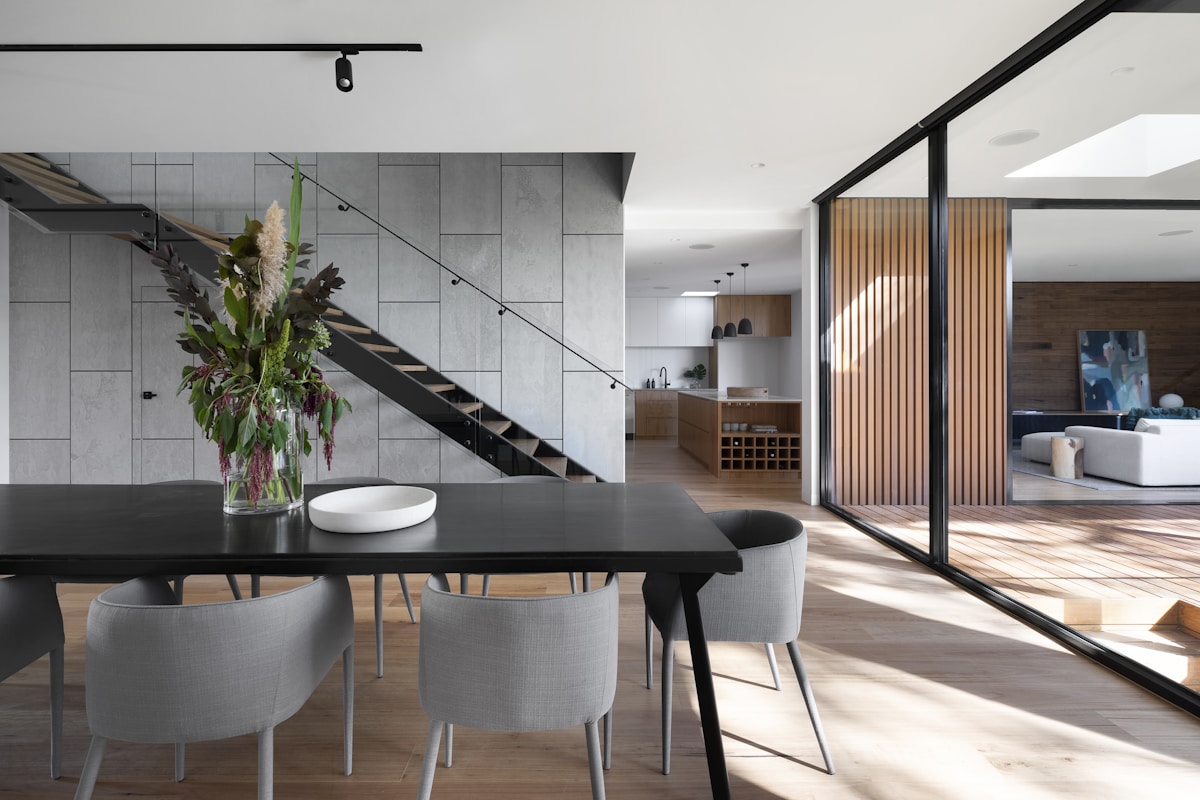 A light-filled contemporary interior with large windows and warm natural materials